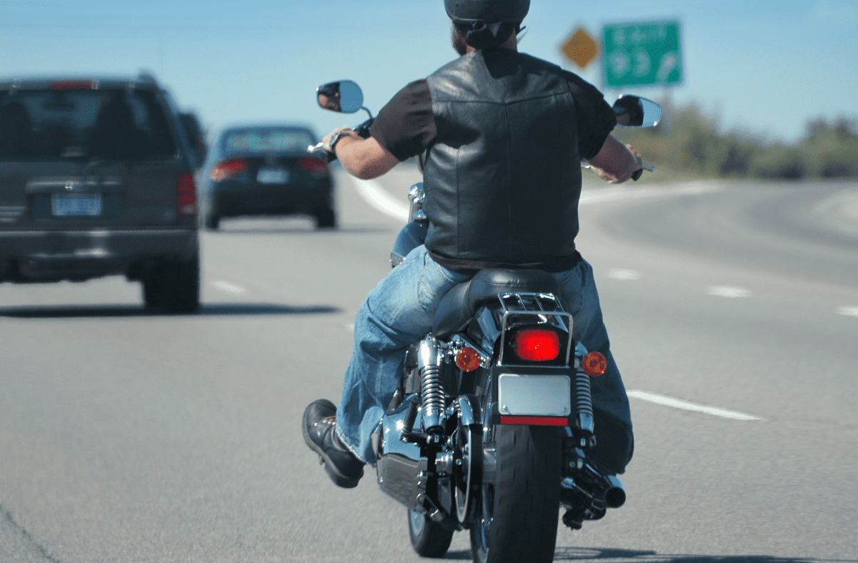 Motorcycle driving on highway in traffic.