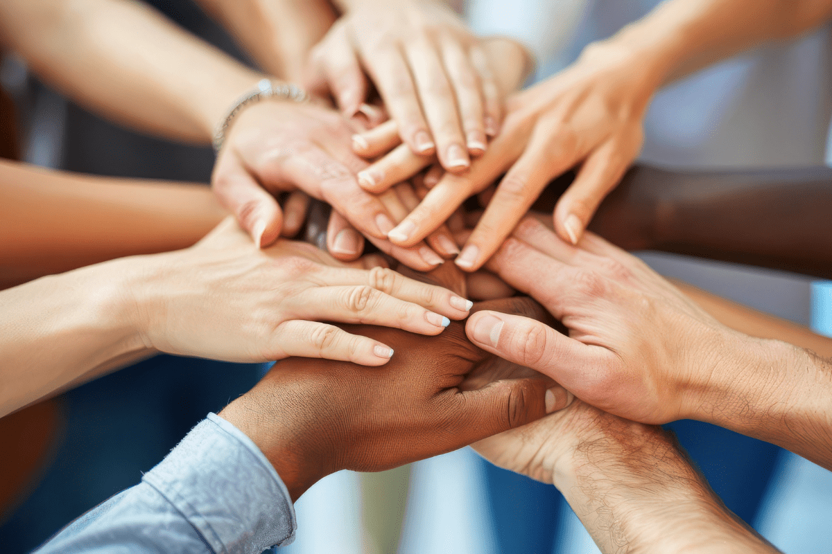 Group of people with hands in at the middle of the circle