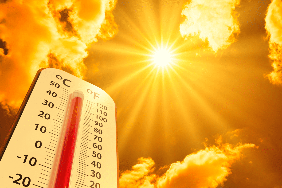 Summer sun in the sky with thermometer in foreground