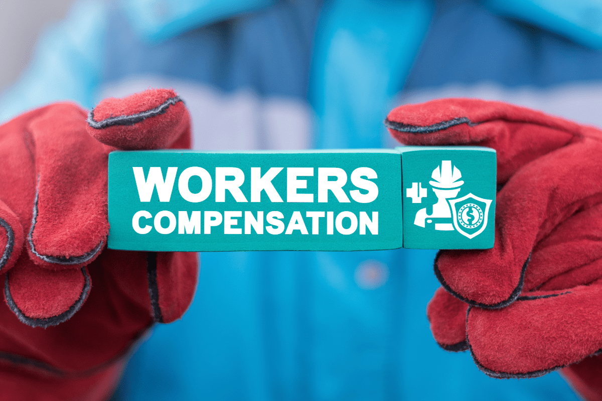 Worker holding up workers compensation blocks.