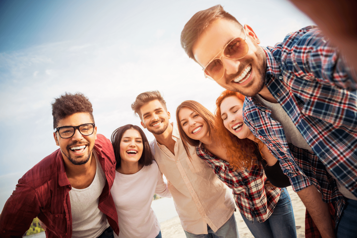 Group of young adults taking a selfie together.