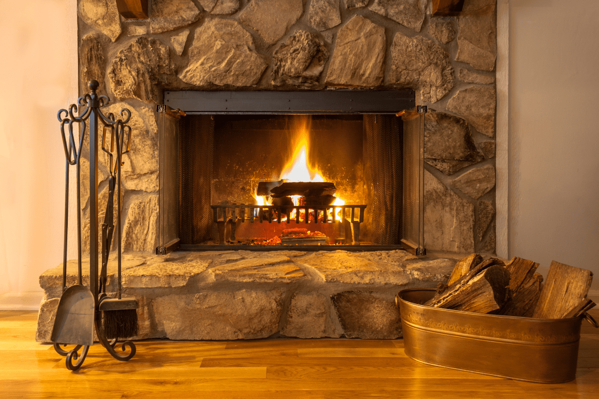 Stone fireplace with active fire going