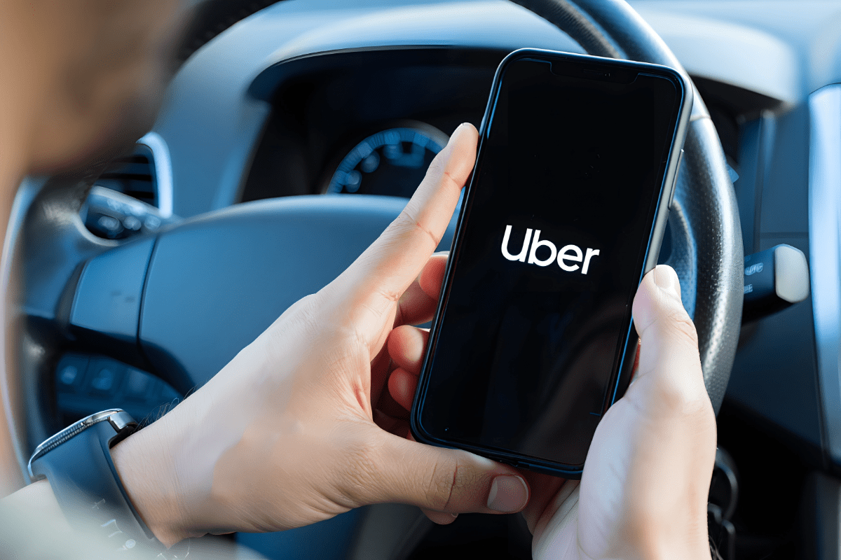 Uber driver opening app while in the driver seat of their personal vehicle
