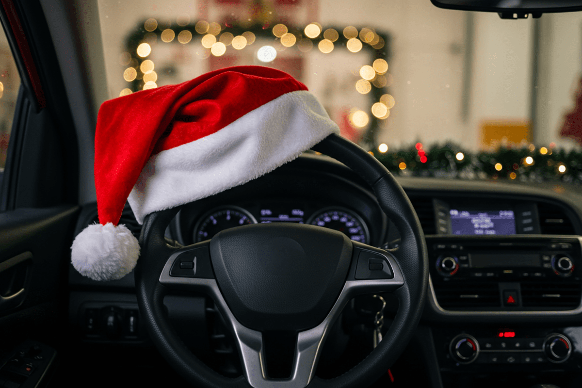 Santa hat sitting on top of car steering wheel